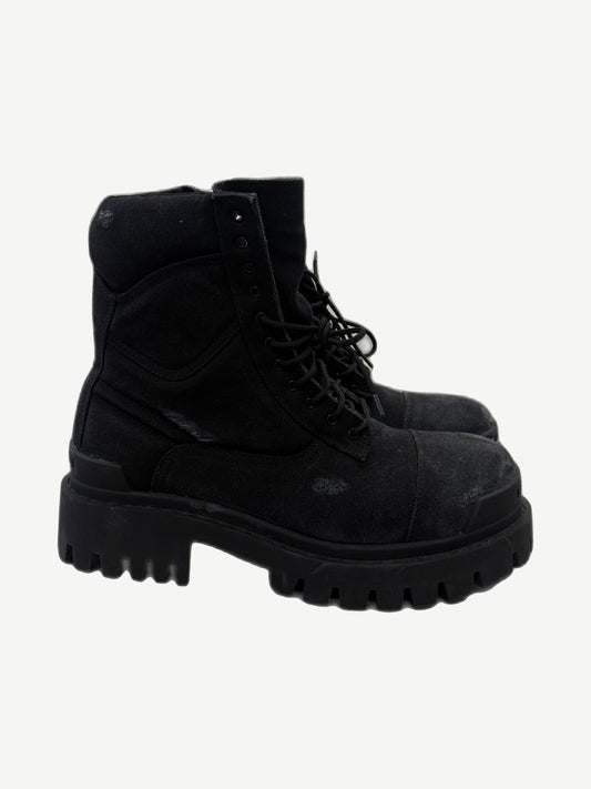 Balenciaga Combat Strike boots in chunky black canvas with lace-up military-style upper and exaggerated lugged sole.
