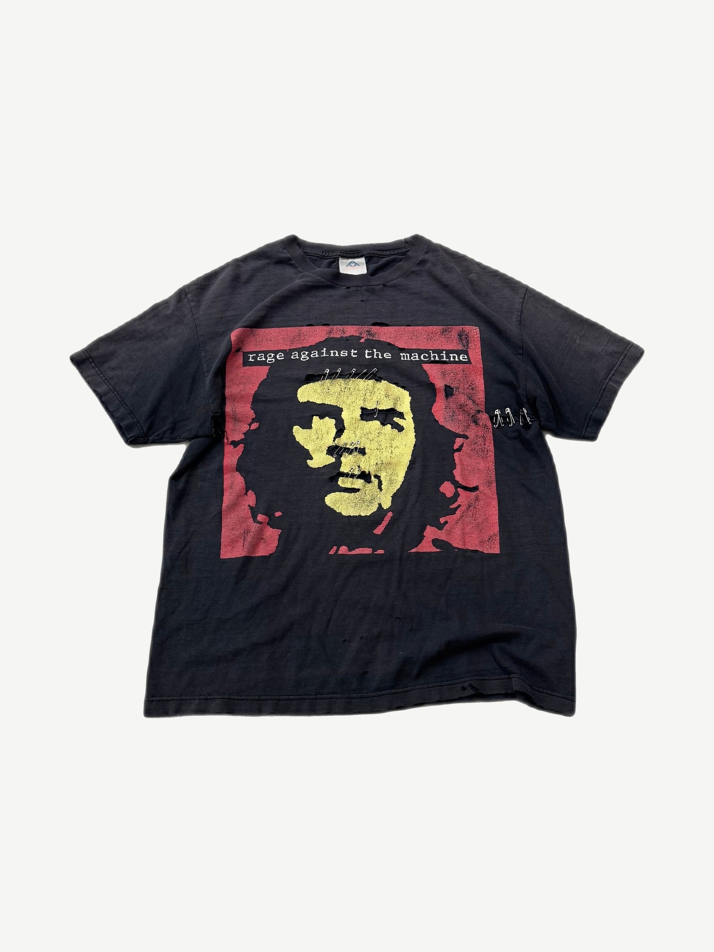 Vintage Rage Against the Machine black tee with red Che Guevara square graphic and safety pin details.
