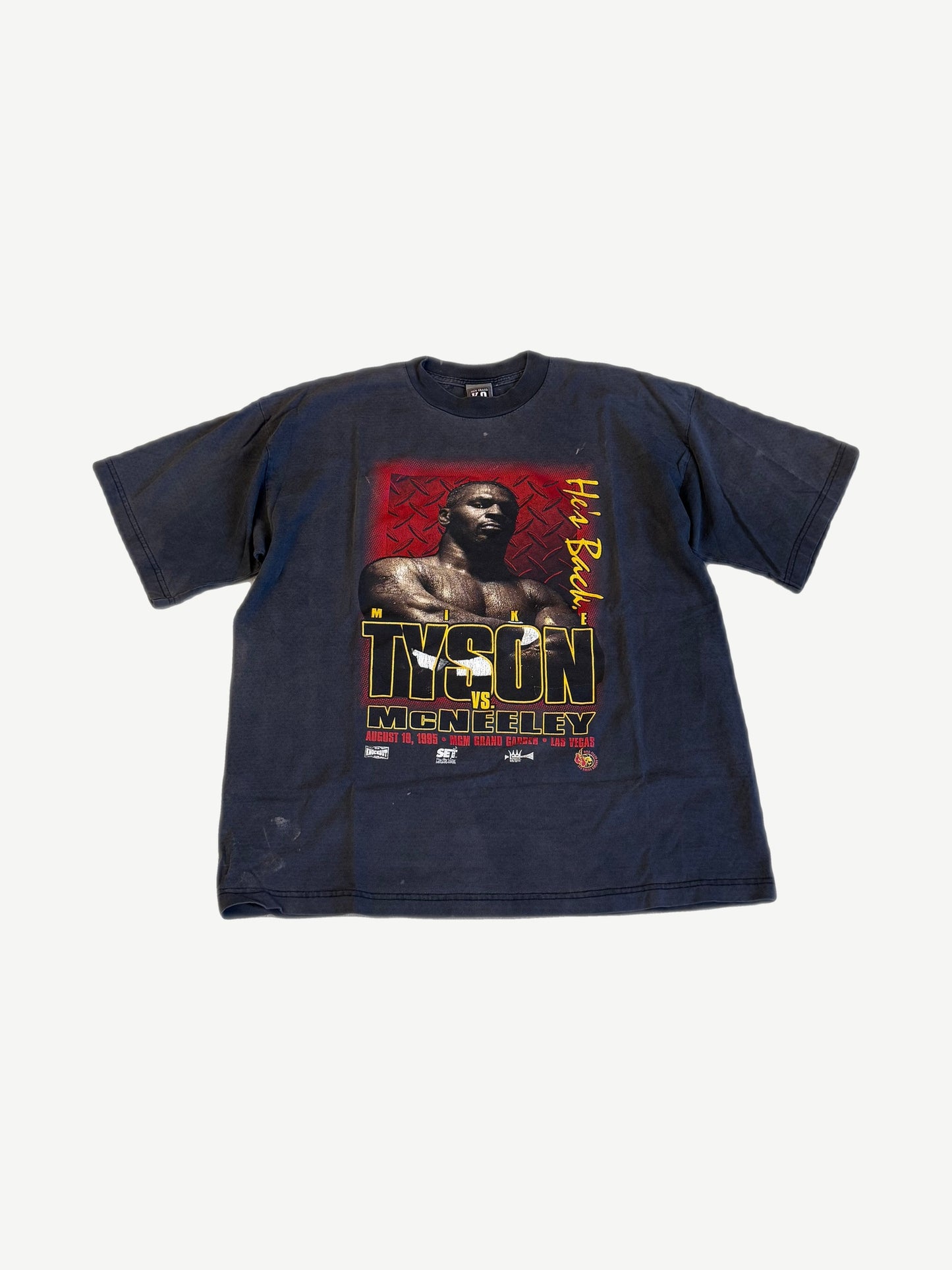Vintage Mike Tyson vs McNeeley 1995 MGM Grand Las Vegas boxing tee in faded navy with bold He's Back graphic