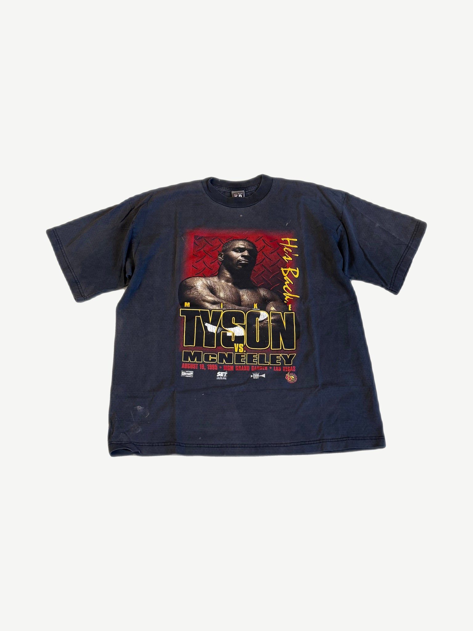 Vintage Mike Tyson vs McNeeley 1995 MGM Grand Las Vegas boxing tee in faded navy with bold He's Back graphic