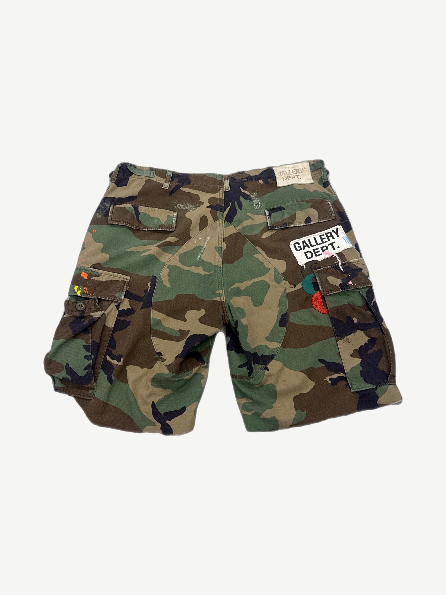 Gallery Dept camouflage cargo shorts, back view showing flap pockets on faded military print