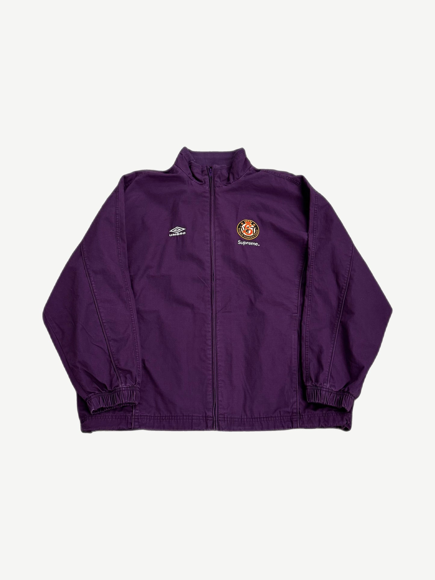 Supreme x Umbro plum purple cotton ripstop track jacket front with Umbro diamond and Supreme world famous crest