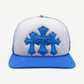 Chrome Hearts blue and white trucker hat with three blue leather cross patches stitched on front panel.