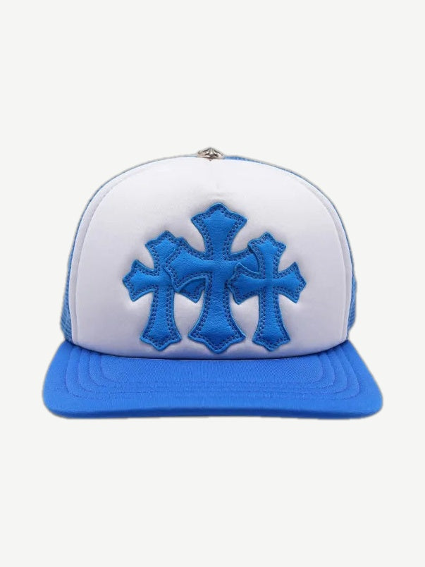 Chrome Hearts blue and white trucker hat with three blue leather cross patches stitched on front panel.