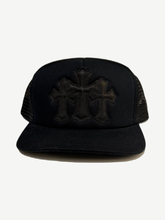 Chrome Hearts black trucker hat front with three stitched leather cross patches on twill crown and mesh sides