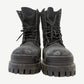 Balenciaga Black Combat Strike boot side view showing tall canvas shaft, padded collar and bulky black rubber sole.