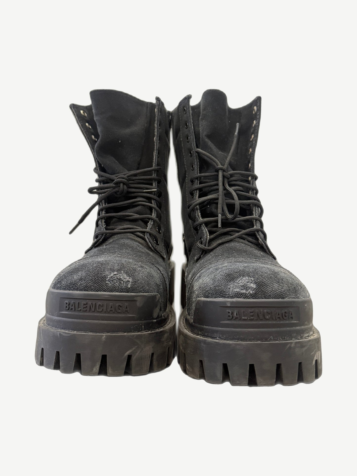 Balenciaga Black Combat Strike boot side view showing tall canvas shaft, padded collar and bulky black rubber sole.
