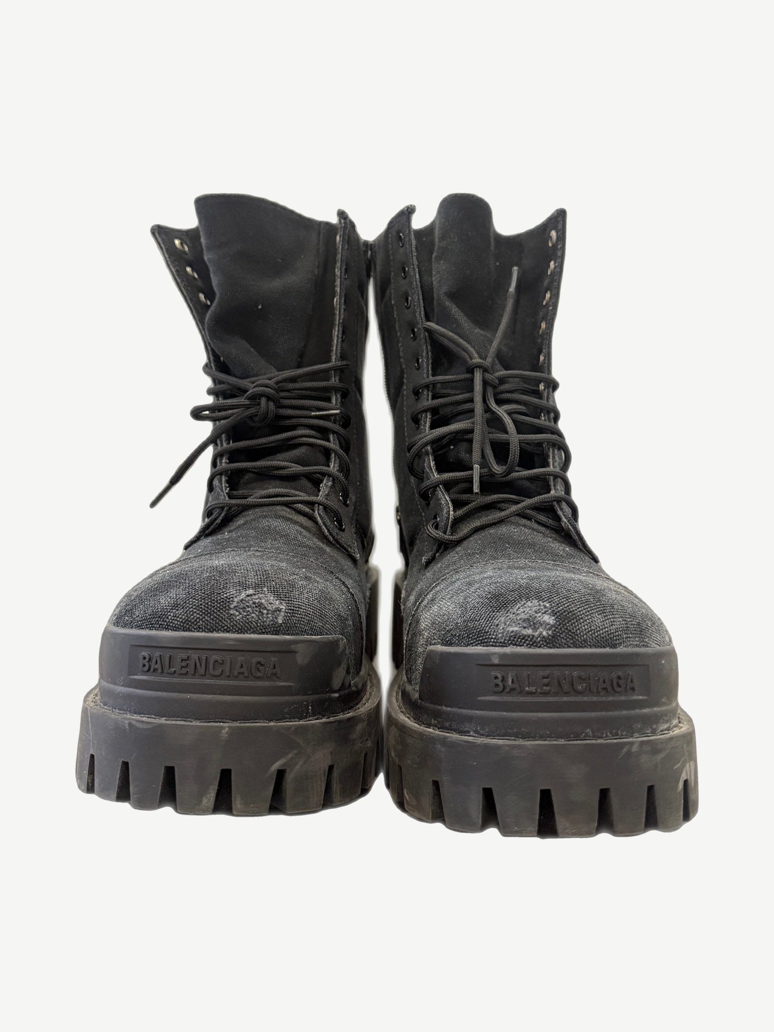 Balenciaga Black Combat Strike boot side view showing tall canvas shaft, padded collar and bulky black rubber sole.