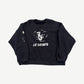 Enfants Riches Deprimes Le Rosey black raglan crewneck front with white gothic text and school crest graphic.