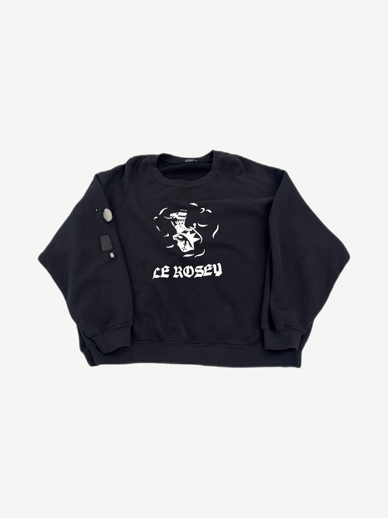 Enfants Riches Deprimes Le Rosey black raglan crewneck front with white gothic text and school crest graphic.