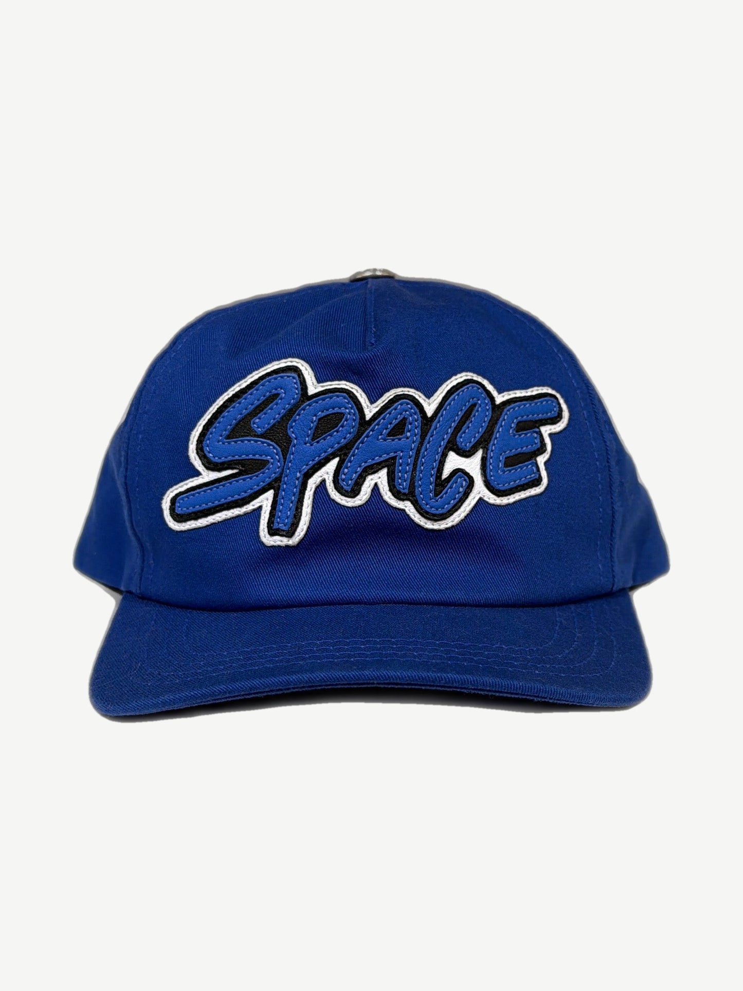 Chrome Hearts Matty Boy royal blue 5-panel hat front, white SPACE graffiti leather patch and short curved brim.