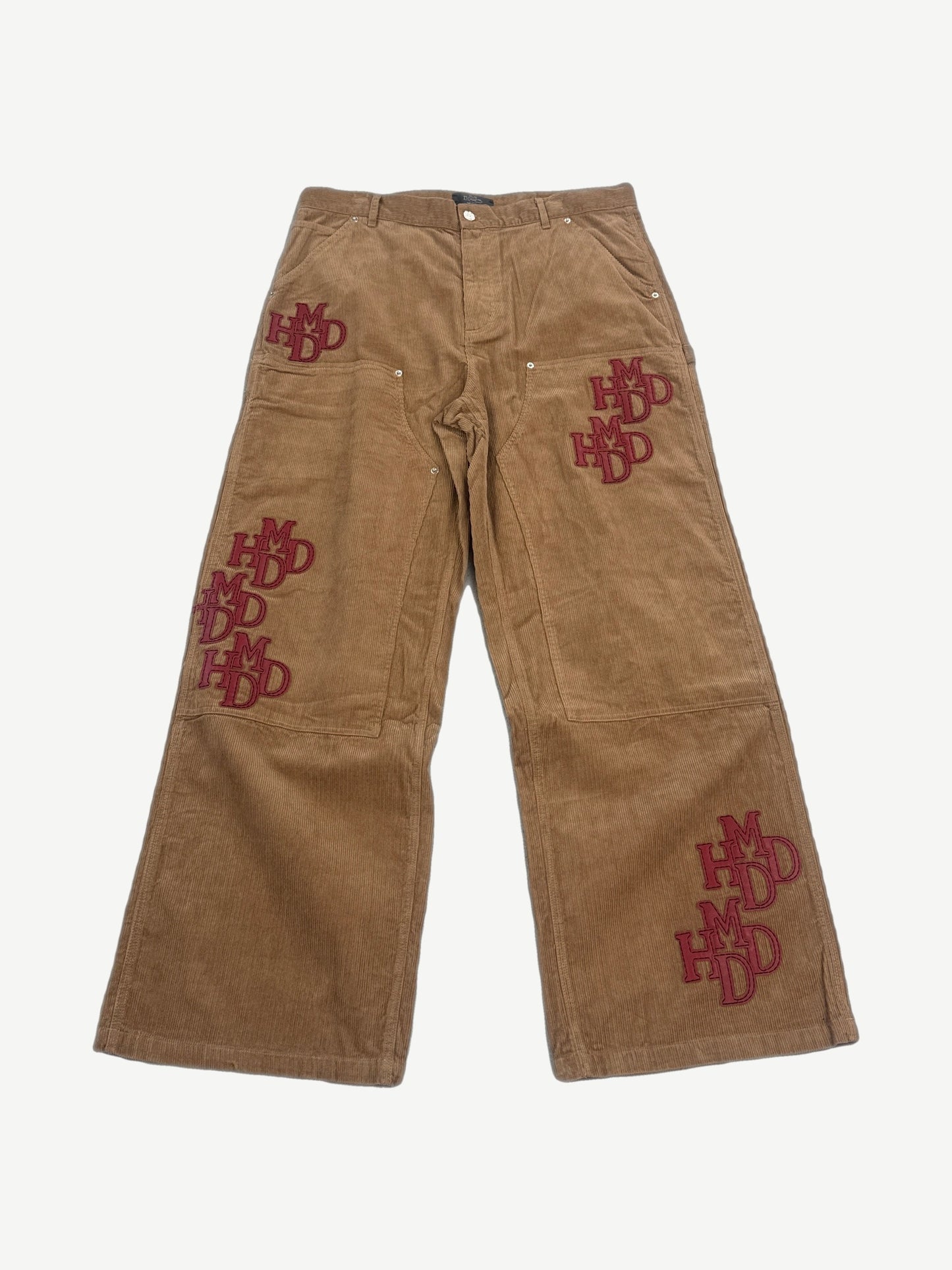 Happy Memories Don't Die HMDD tan corduroy pants front with stacked red HMDD monogram patches on legs
