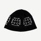 West Coast Choppers black beanie top view showing repeating white iron cross knit pattern.
