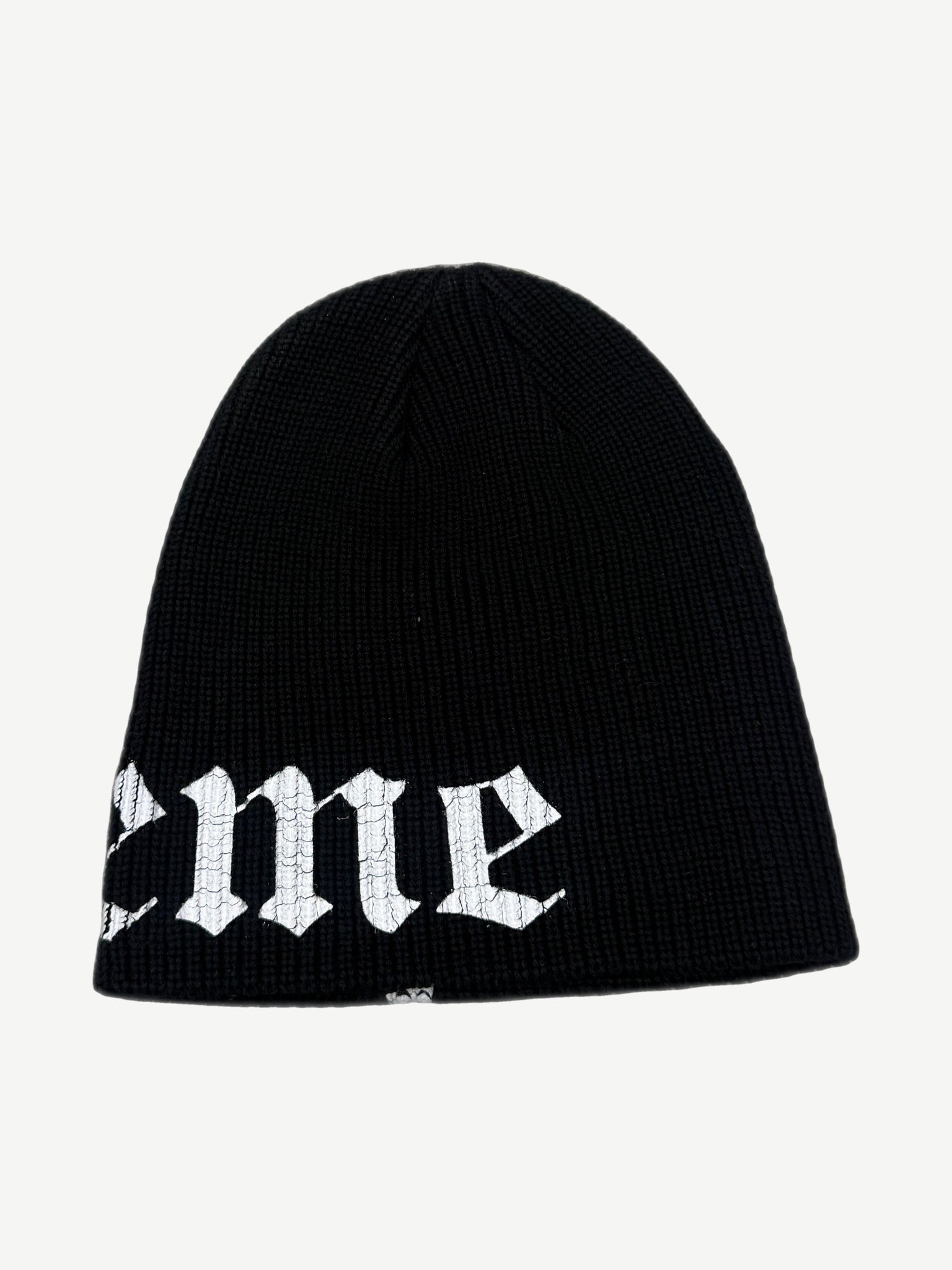Supreme black beanie reverse side view showing tail of Old English Supreme script logo on the ribbed cuff