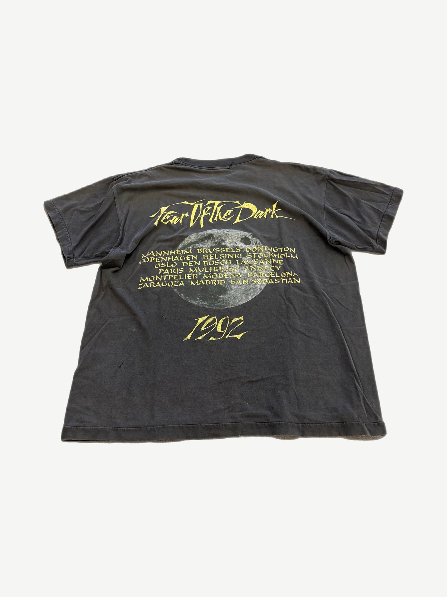 Back of vintage Iron Maiden Fear of the Dark tour tee with band logo and tour date list on faded black.