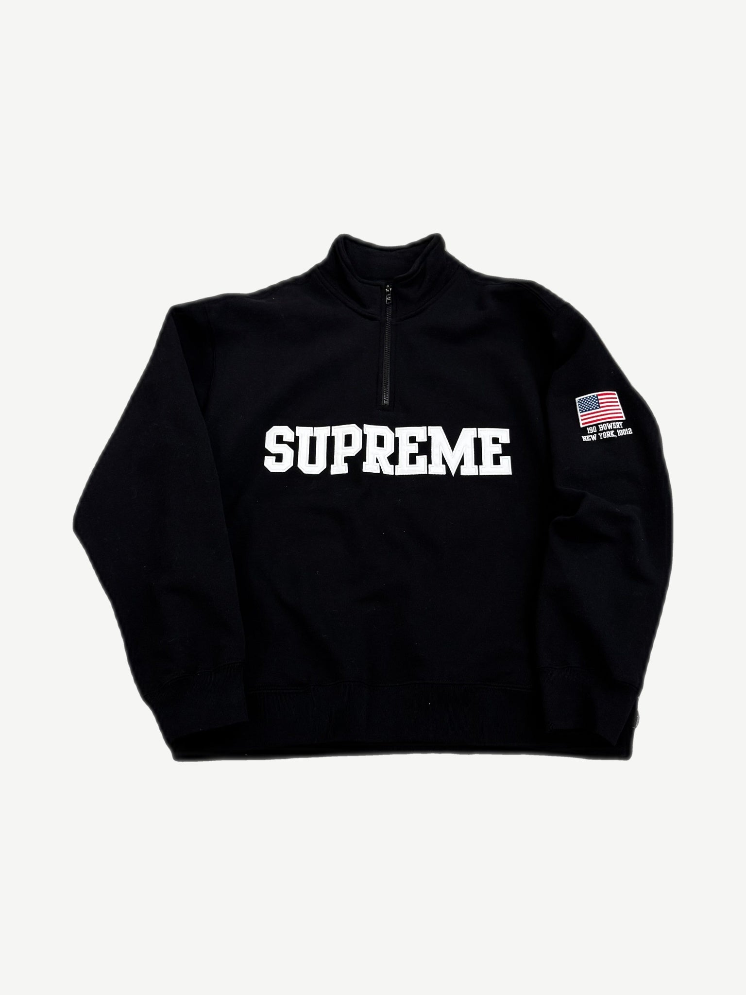 Supreme black half-zip pullover with white varsity text, US flag and Bowery patch on chest