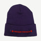 Back of Chrome Hearts purple beanie showing red Old English Chrome Hearts script embroidery on cuff