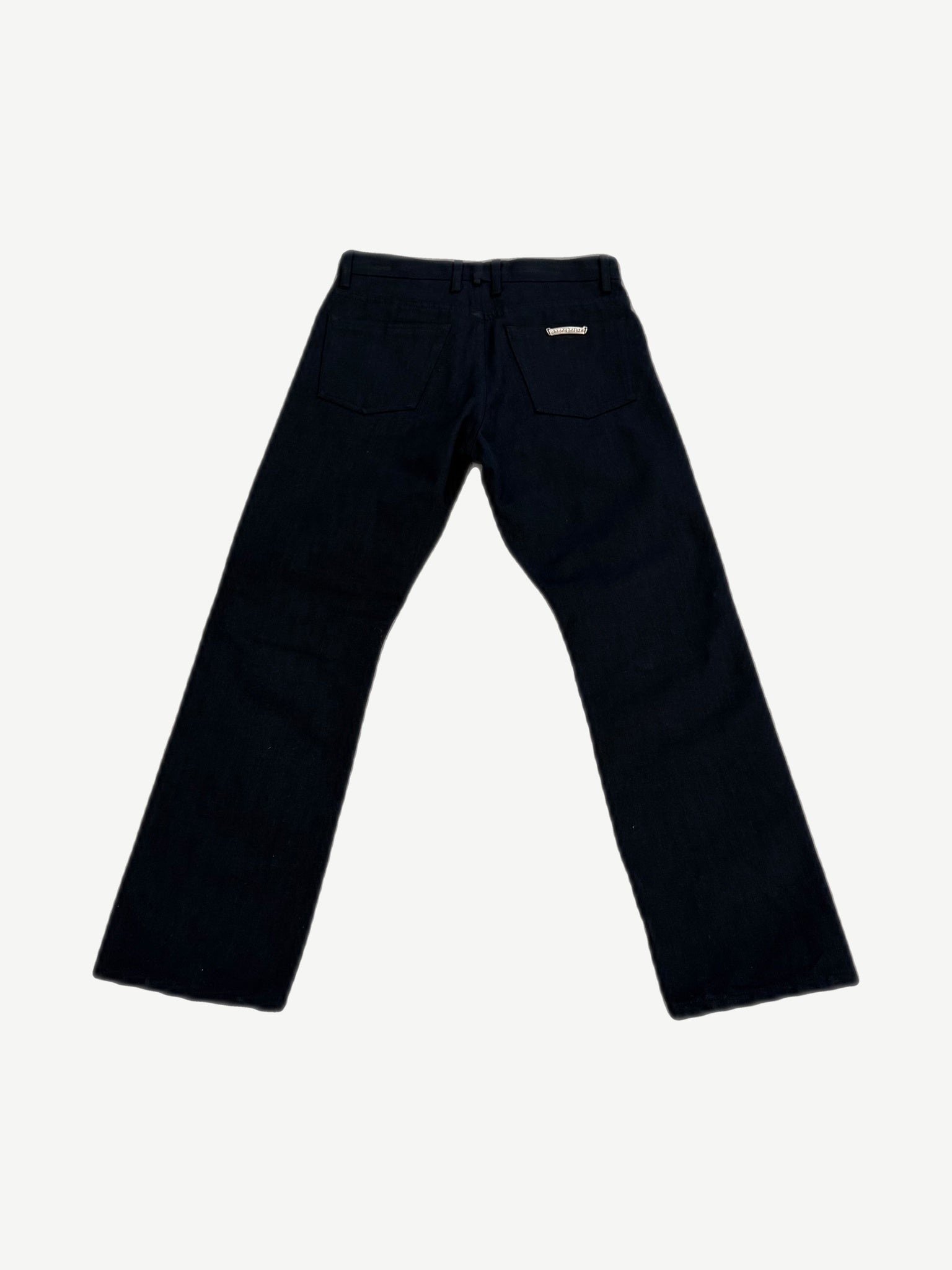 Chrome Hearts black Fleur jeans back view with five-pocket cut and embossed leather waistband tag