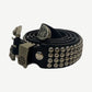 Enfants Riches Deprimes black leather coin belt coiled, showing skull and iron cross hardware with engraved tip