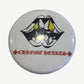Chrome Hearts Matty Boy enamel pin in yellow and red with Matty Boy character figure and crisp outlines.