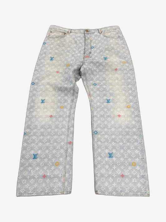 Louis Vuitton x Tyler the Creator denim jeans, mid-wash blue with tonal LV monogram jacquard pattern, straight leg.