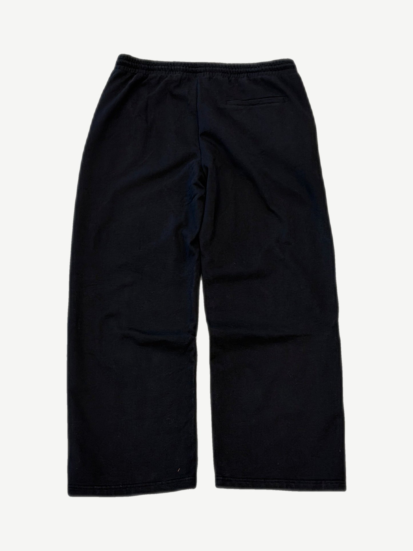 Bottega Desires black tech sweatpants back view, sleek nylon construction with rear welt pocket and tapered cuffs.