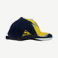 Supreme MM6 Maison Margiela split 6-panel cap side view with navy panel, yellow Supreme triangle and shark fin