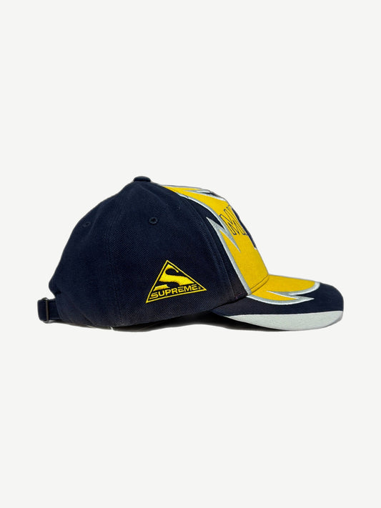 Supreme MM6 Maison Margiela split 6-panel cap side view with navy panel, yellow Supreme triangle and shark fin