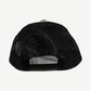Back panel of Chrome Hearts black LA trucker cap showing black mesh paneling and snapback closure strap.