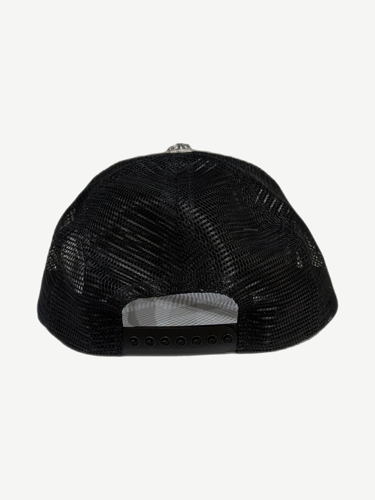 Back panel of Chrome Hearts black LA trucker cap showing black mesh paneling and snapback closure strap.