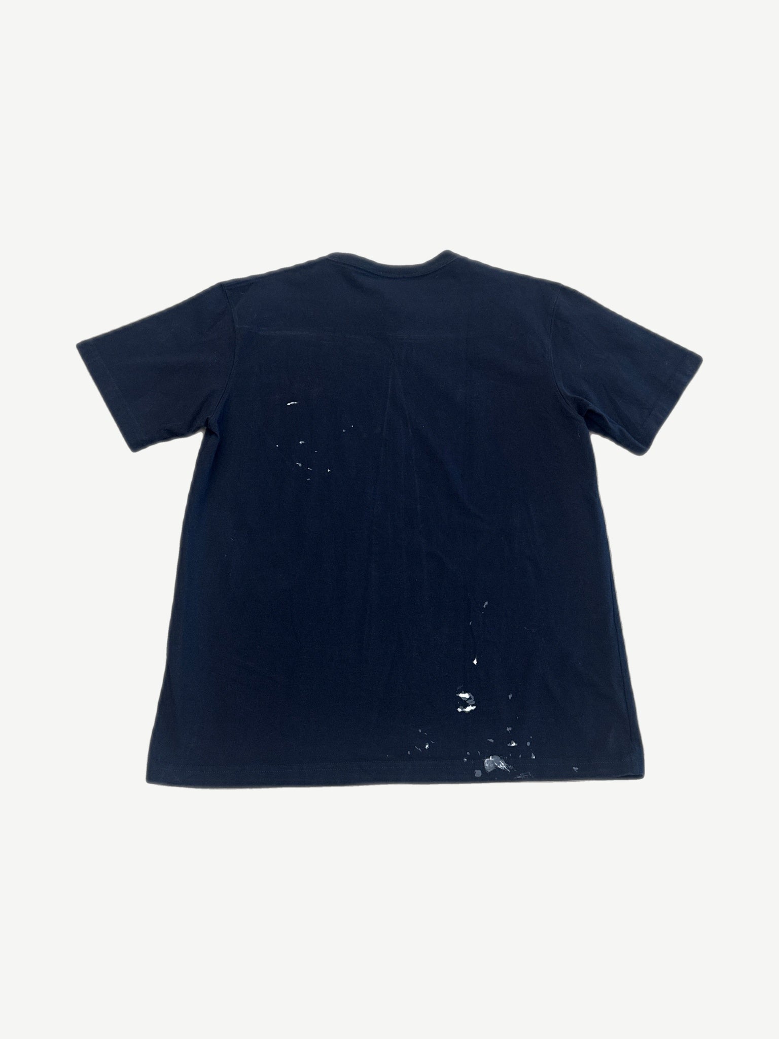 Dior x Cactus Jack navy oversized tee back view with white paint splatter detailing on lower hem