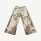 HMDD tan wide-leg chino pants with all-over black and white graffiti scribble print