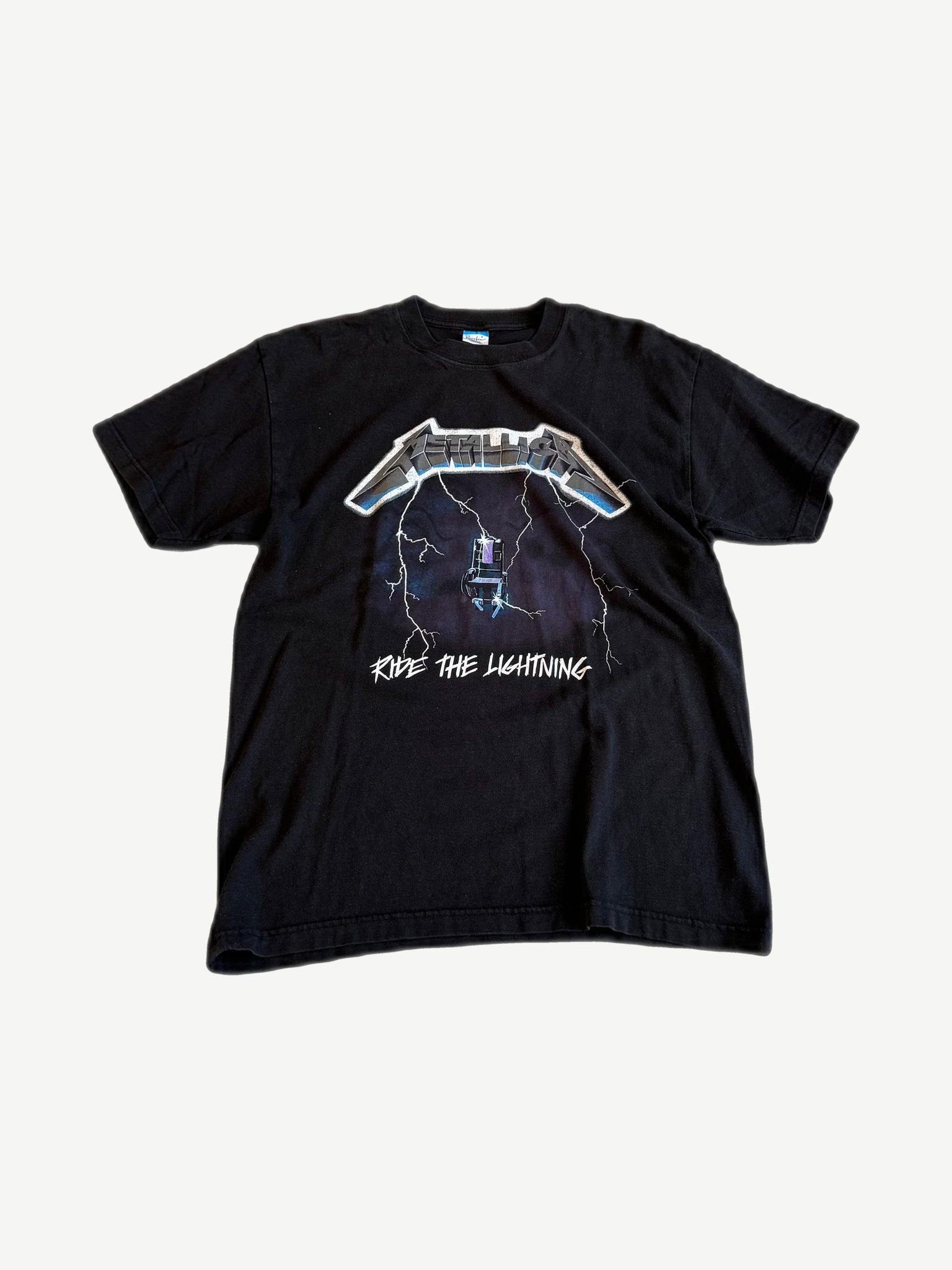 Vintage Metallica Ride the Lightning black tee front with chrome logo and electric chair album art