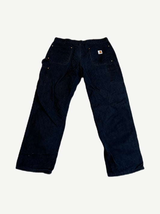 Vintage Carhartt black double knee carpenter pants back with orange Carhartt label on rear pocket and hammer loop