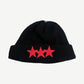 Chrome Hearts black cashmere ribbed beanie front, three red leather star patches on cuff with silver CH cross top.