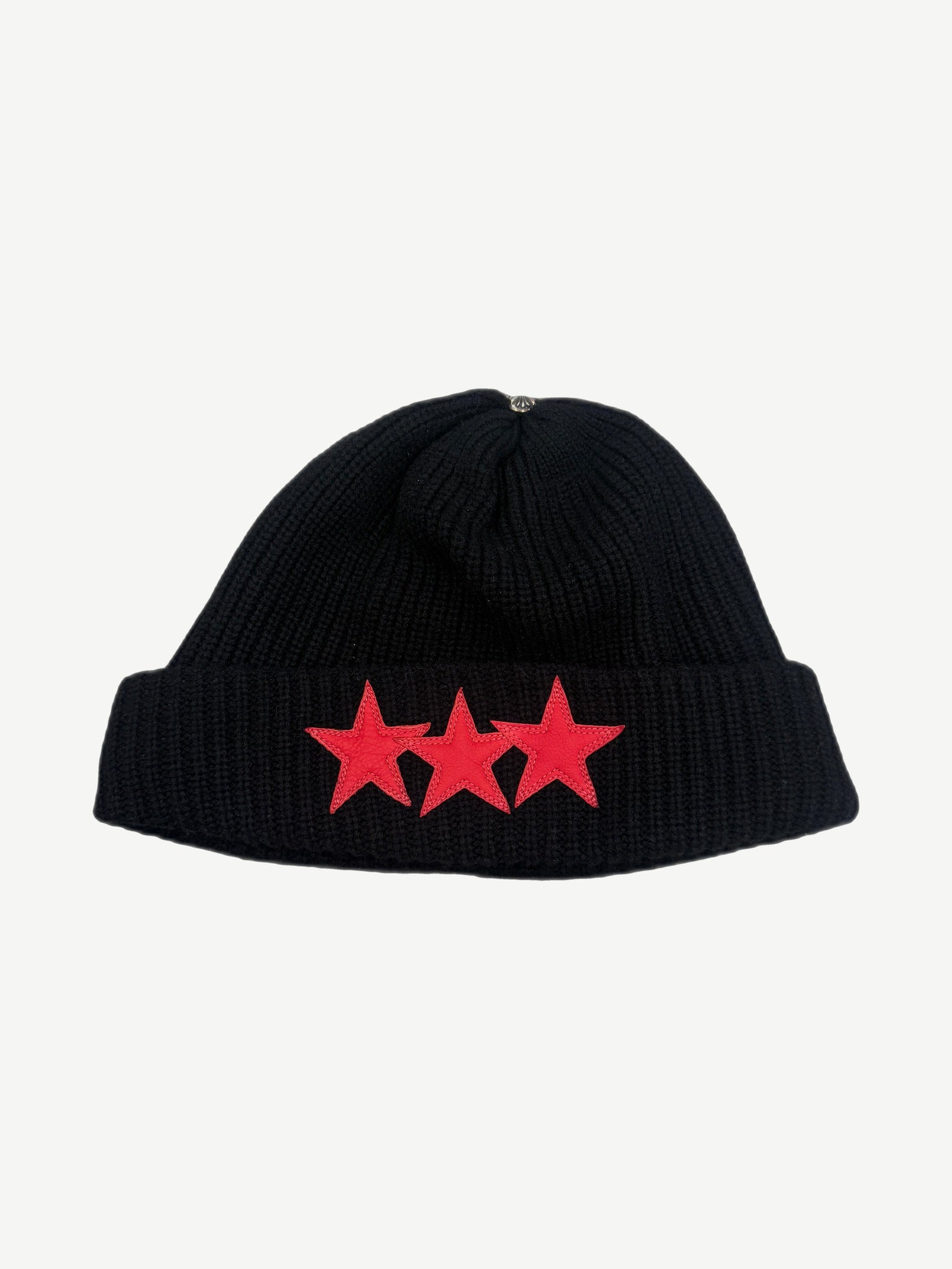 Chrome Hearts black cashmere ribbed beanie front, three red leather star patches on cuff with silver CH cross top.