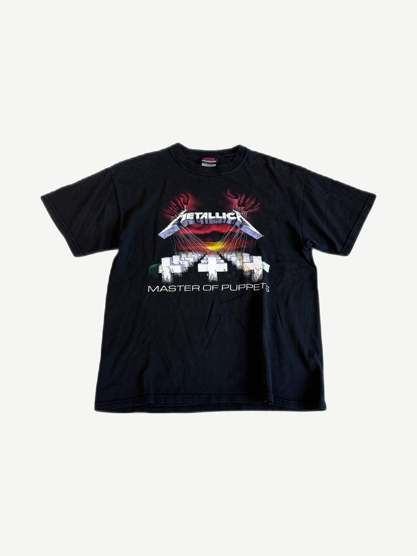 Vintage Metallica Master of Puppets tour tee, black cotton with classic crosses graveyard graphic front print.