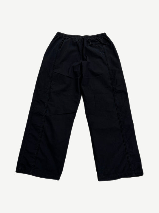 Supreme Umbro black ripstop track pants back view, clean black panels with right rear zip pocket detail.