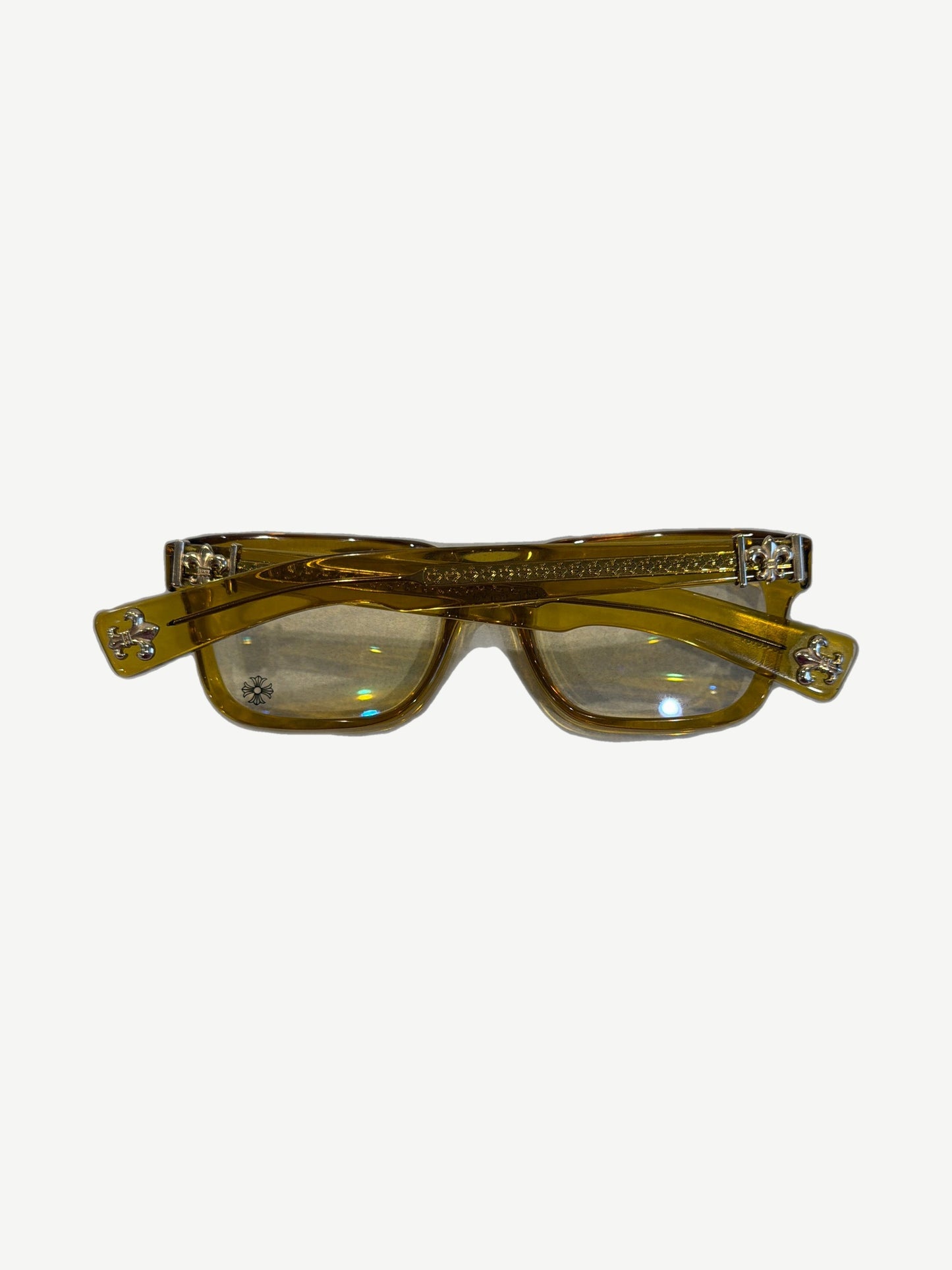 Chrome Hearts yellow glasses side view showing engraved temples with sterling silver dagger logo accents