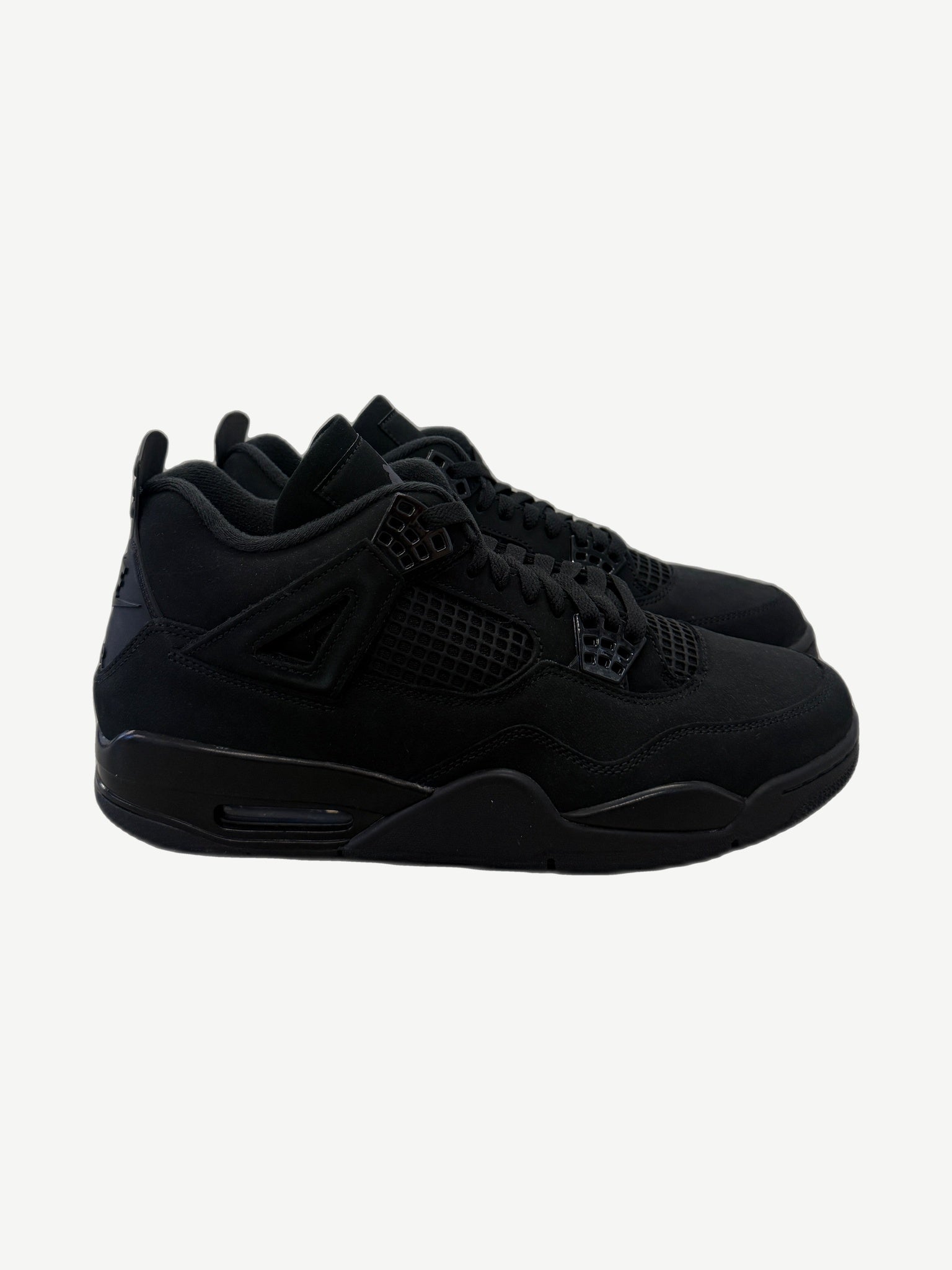 Air Jordan 4 Black Cat 2025 sneakers in tonal black nubuck with mesh side panels and tonal eyelets, side profile