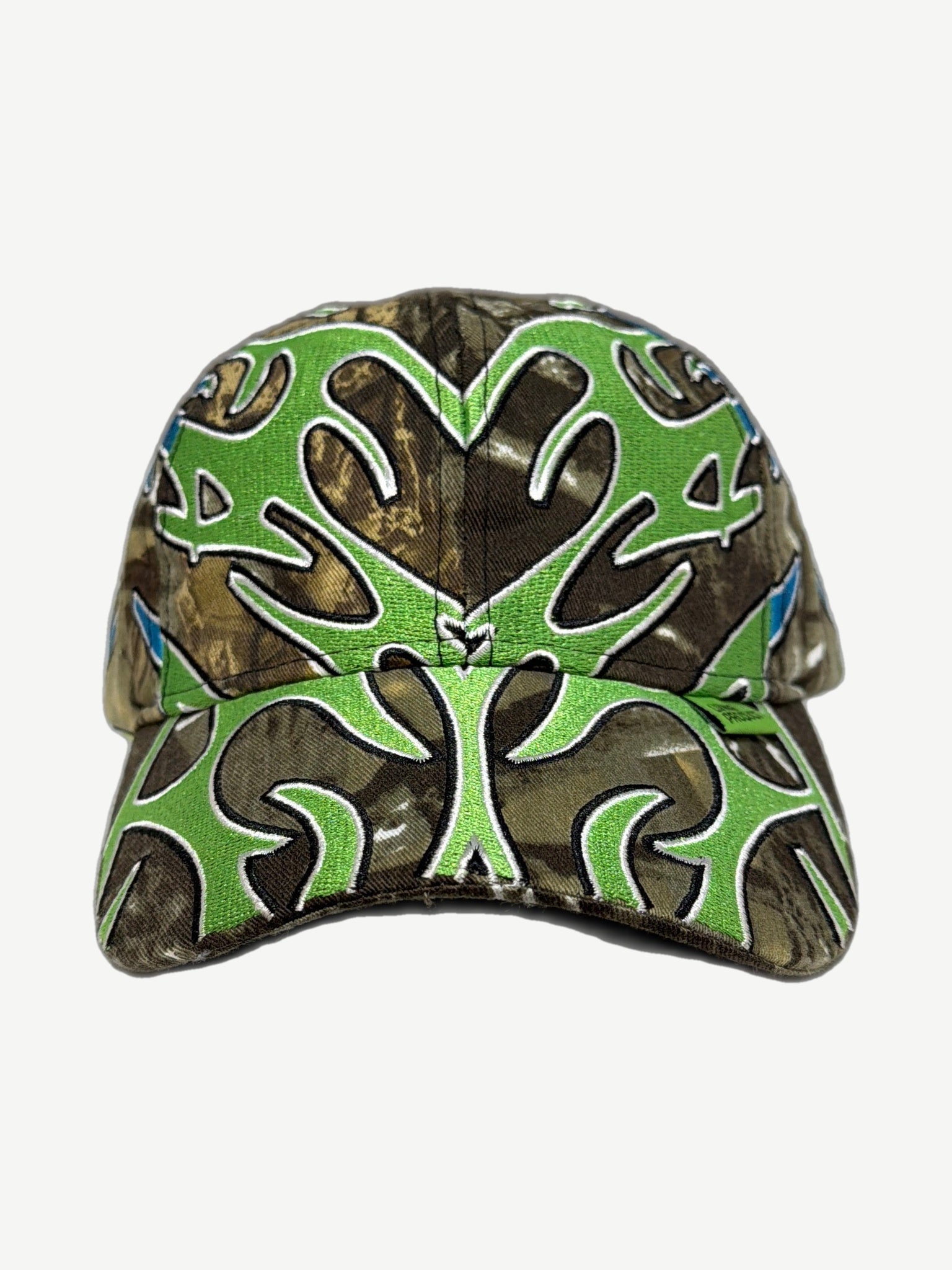 Living Product Man Vs Nature cap in brown camo with green and blue tribal antler embroidery across crown and brim