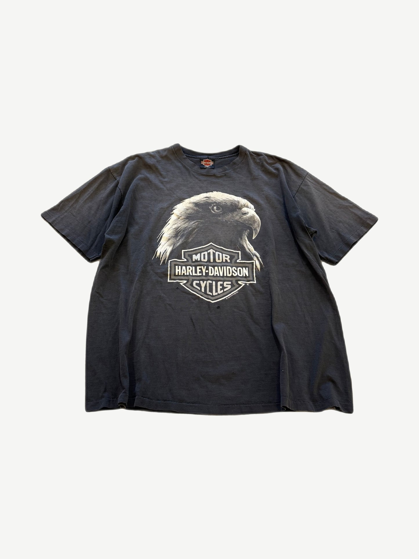 Vintage Harley Davidson faded black tee front with eagle head graphic over bar and shield motorcycles logo
