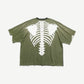 Kapital two-tone pocket tee back, olive green panel with large white bone ribcage and spine print.