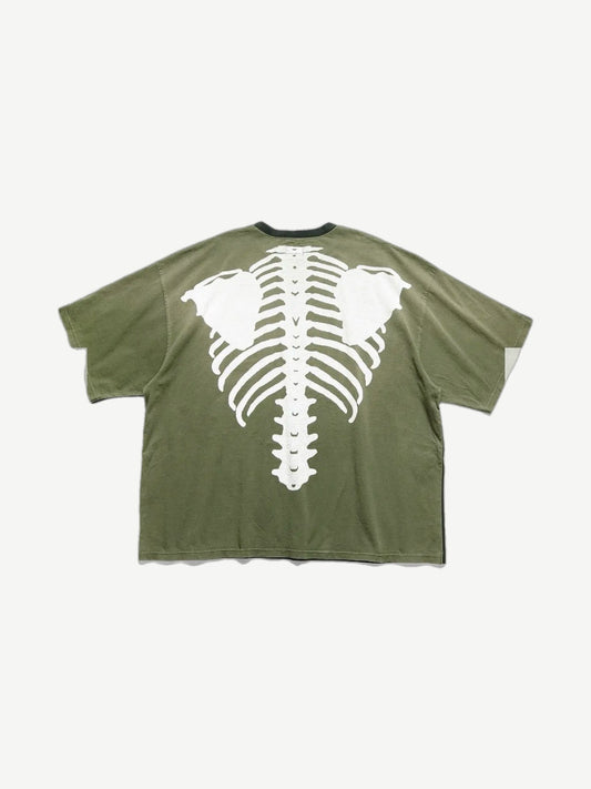 Kapital two-tone pocket tee back, olive green panel with large white bone ribcage and spine print.