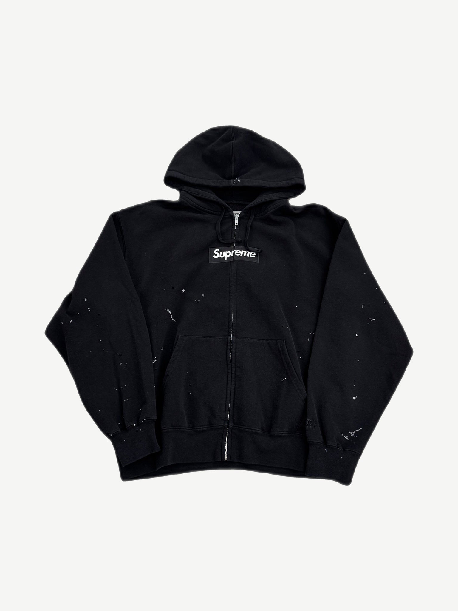 Supreme MM6 Maison Margiela black zip hoodie front view with red box logo on chest panel.
