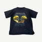 Vintage Metallica faded black tee front with Pushead twin yellow skulls fighting graphic and metallica logo print.