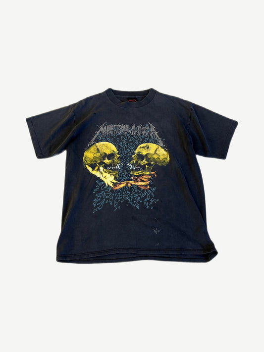 Vintage Metallica faded black tee front with Pushead twin yellow skulls fighting graphic and metallica logo print.