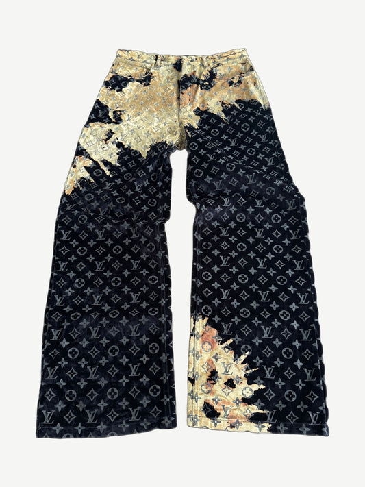 Louis Vuitton bleach monogram wide-leg jeans in black with gold bleach splatter wash across allover LV pattern