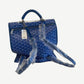 Goyard blue Saint Leger backpack angled view showing zip pocket, hangtag and wrapped leather shoulder straps