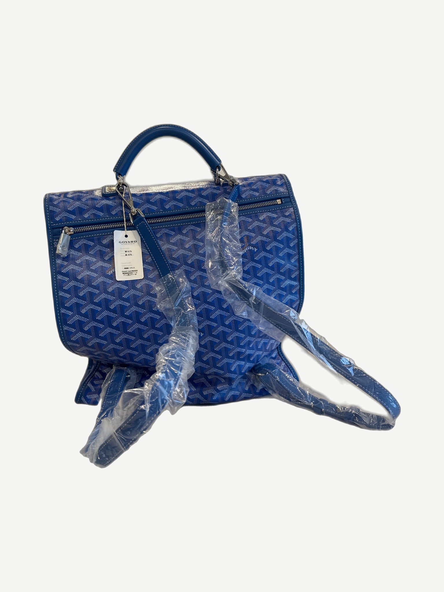 Goyard blue Saint Leger backpack angled view showing zip pocket, hangtag and wrapped leather shoulder straps